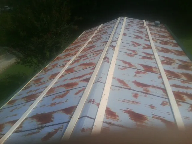 Rusted metal roof panels with new wood purlins before replacement — Storm Damage Roof Repair in Selmer by Roofing Brothers