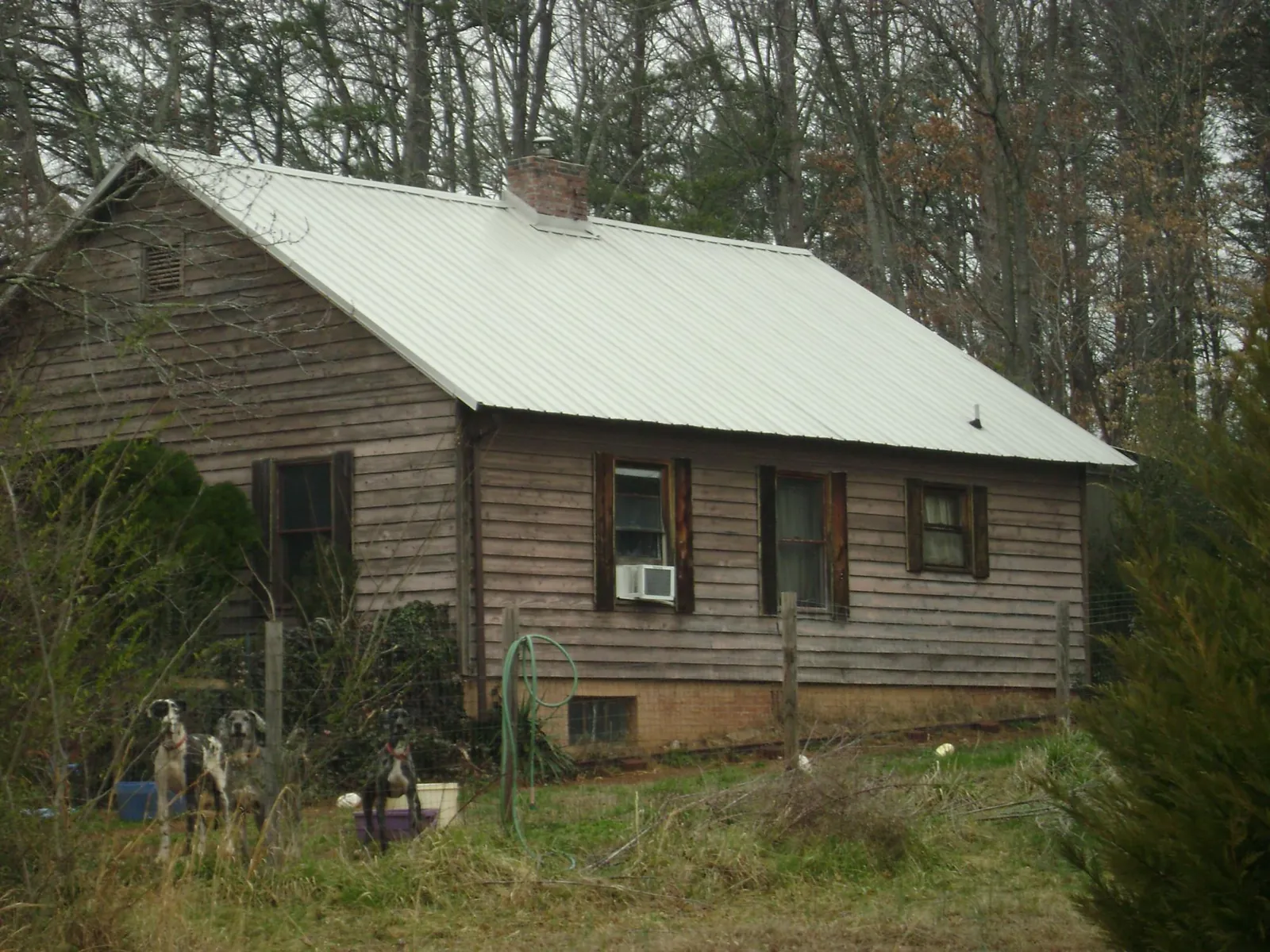 White metal roof on an old wood sided farmhouse, from a Metal Roof Installation job in Selmer